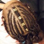 Cornrolls style on kids hair with added decorations conroll, cornroll